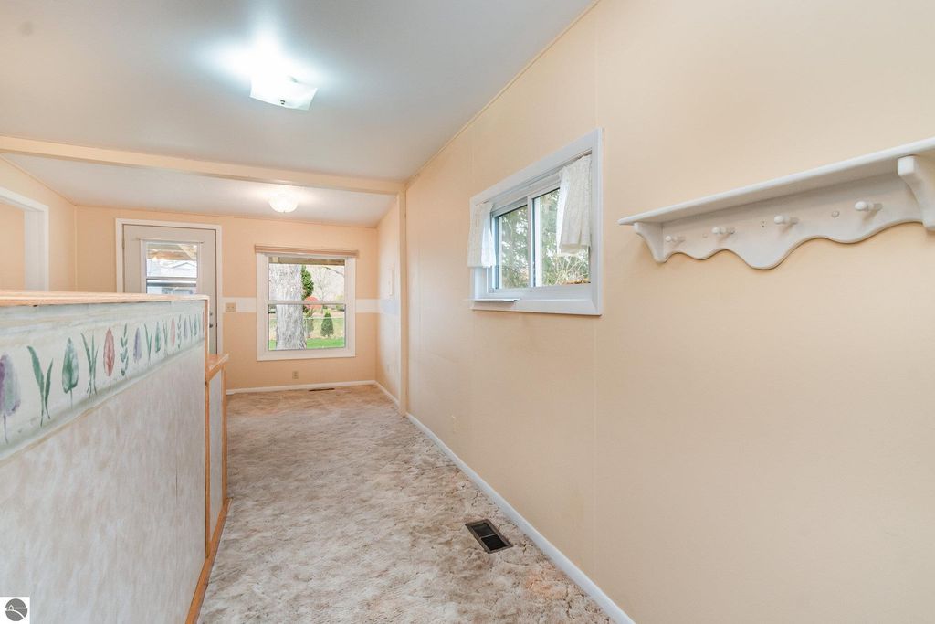 Interior view of a move-in ready home featuring a mudroom entry, light-colored walls, and a decorative floral border, located at 1435 E Broadway Street, Mt Pleasant, MI.