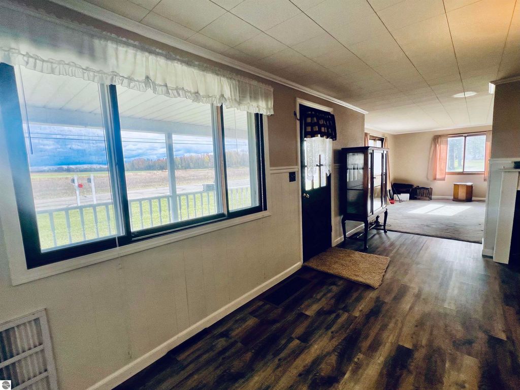 Interior view of home at 889 N Ferris Road, Sumner, MI, showcasing spacious layout, large windows with natural light, and welcoming entryway.