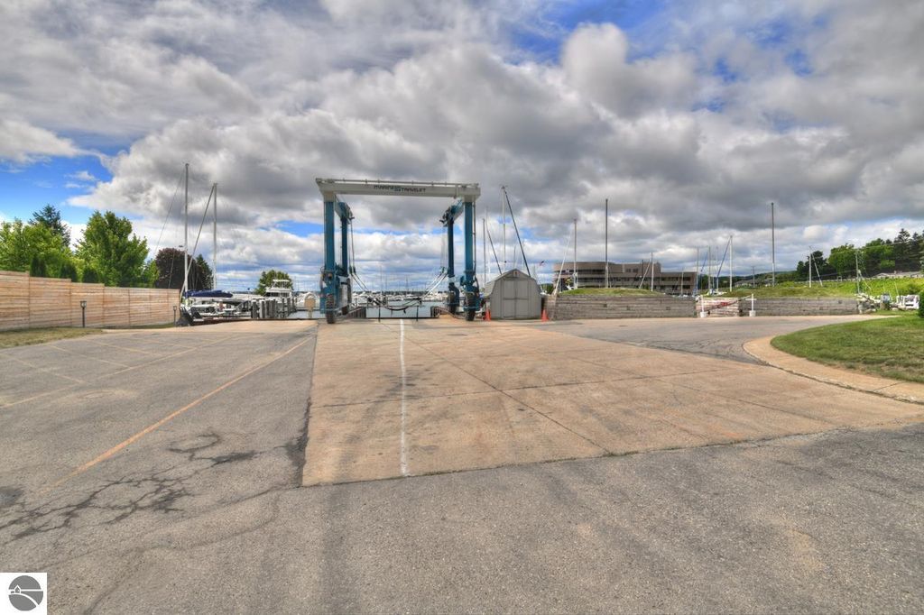 Marina launch area in Traverse City, featuring a boat lift and surrounding docks, ideal for boat enthusiasts seeking access to West Grand Traverse Bay.
