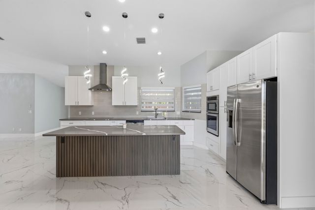 104 Oxford Court, Royal Palm Beach, FL 33411