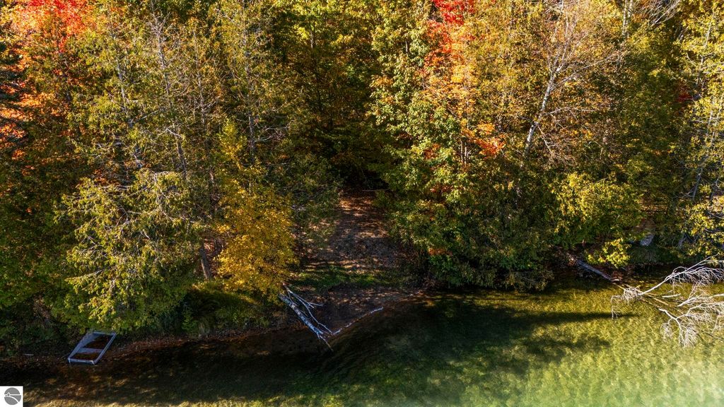 Scenic view of colorful autumn foliage along the shoreline of North Blue Lake, showcasing serene natural beauty and inviting waterfront access for recreational activities.