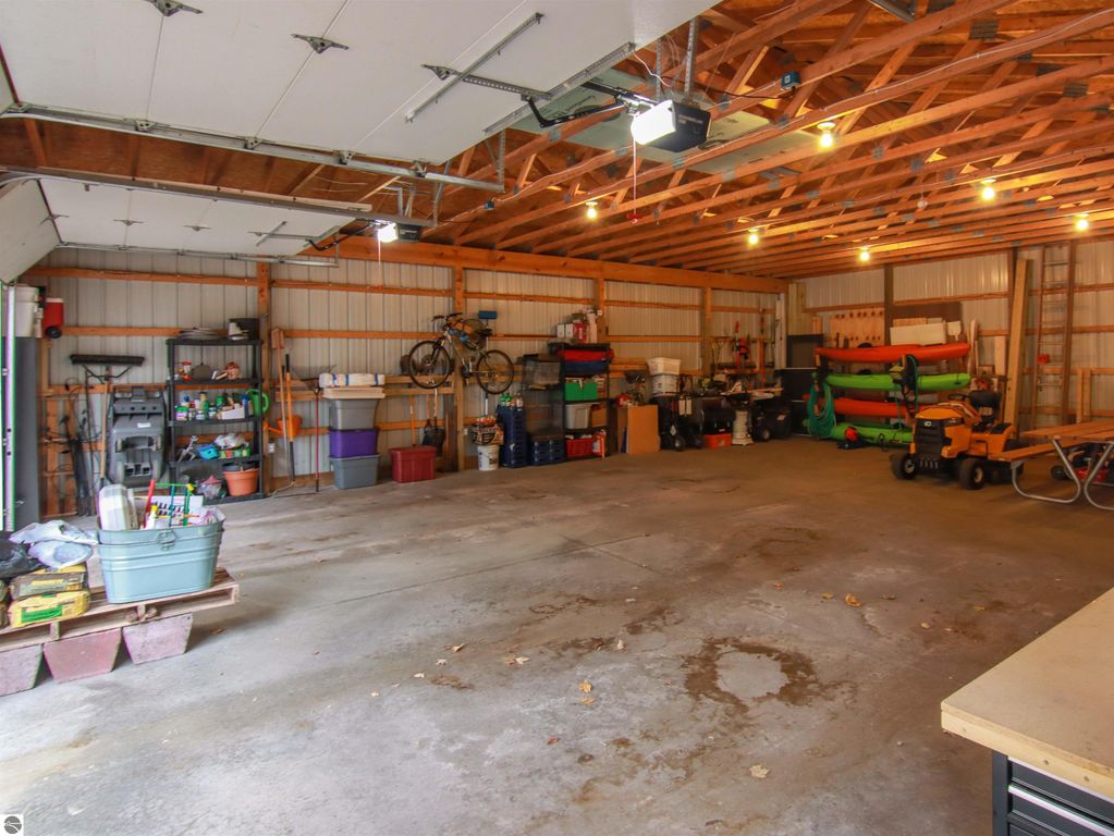 Spacious detached 30x40 pole barn garage with organized storage, bicycles, and various equipment, showcasing ample space for vehicles and hobbies.