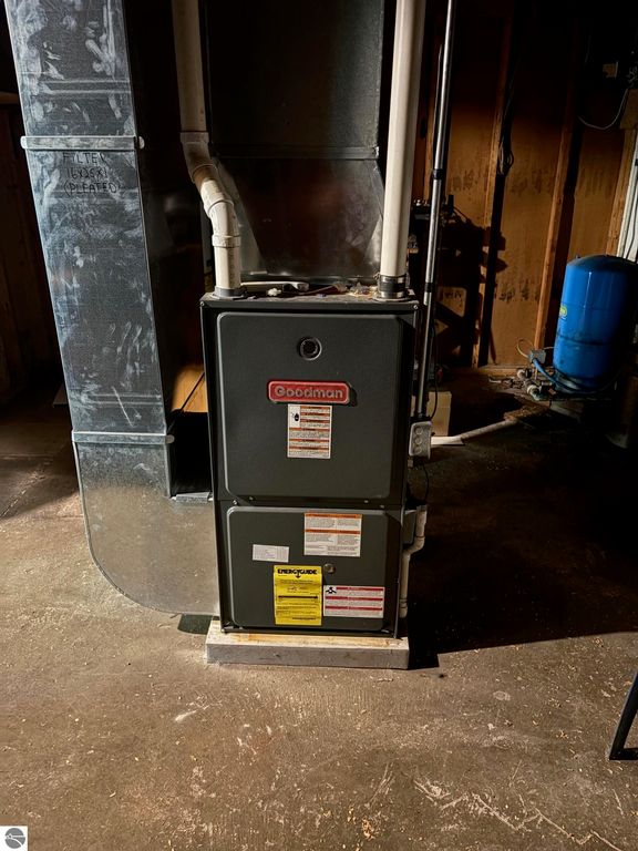 Goodman furnace installed in the basement, showcasing heating system features and nearby plumbing elements in a residential property.