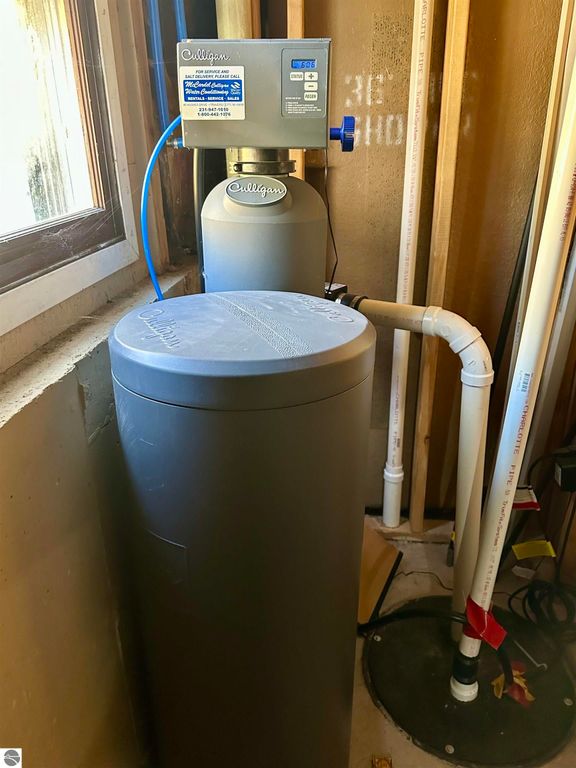 Culligan water softener and filtration system installed in a home, featuring a control unit and connected plumbing, emphasizing the property's updated amenities.