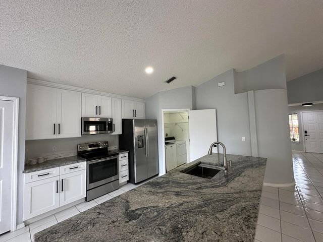 119 Hammocks Court, Greenacres, FL 33413