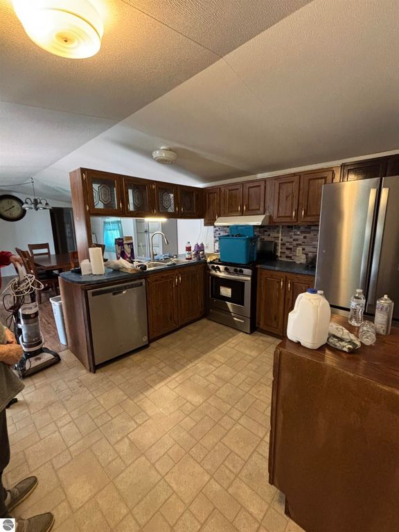 Kitchen interior of manufactured home at 5013 Turner Pine Drive, featuring wooden cabinets, stainless steel appliances, and a spacious layout suitable for a 2 bedroom, 1 bath property.