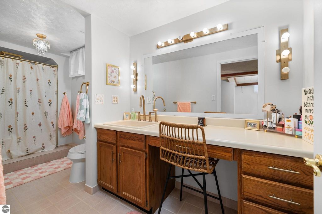 Spacious finished basement room with beige carpeting, white walls, and a small window, ideal for a family room or additional living space in a Traverse City ranch home.