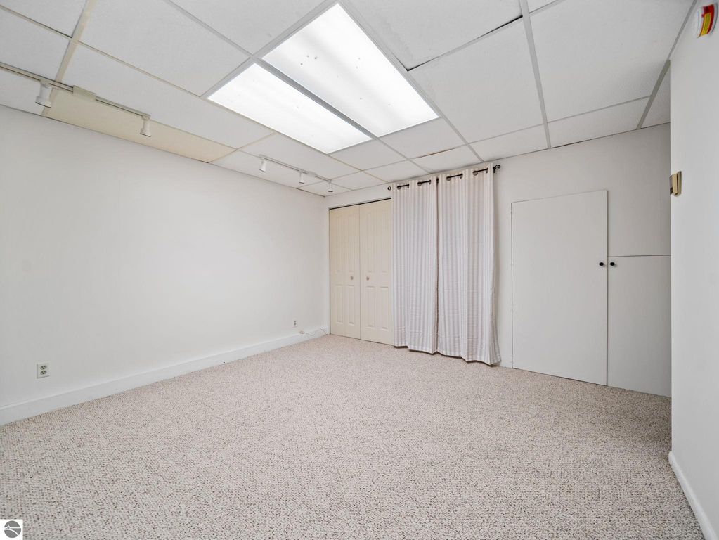 Ranch-style home at 109 Boughey Street, Traverse City, featuring a well-maintained exterior with autumn leaves, surrounded by landscaped yard and trees, showcasing a welcoming atmosphere for potential buyers.