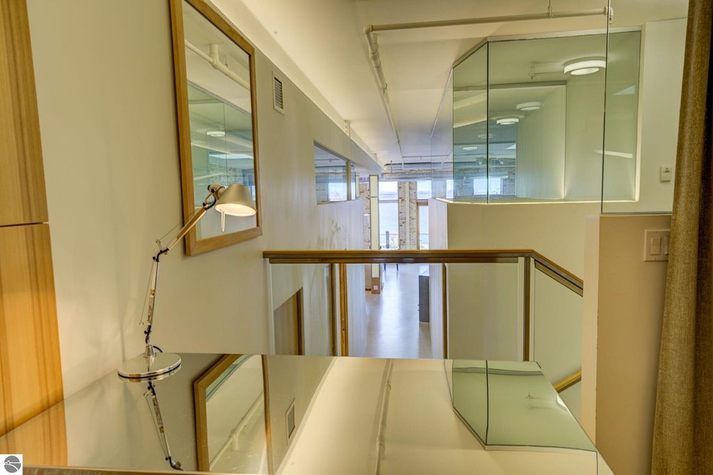 Modern interior view of downtown condo at 237 E Front Street, featuring sleek design elements, large windows, and a balcony overlooking the bay, emphasizing spaciousness and contemporary architecture.