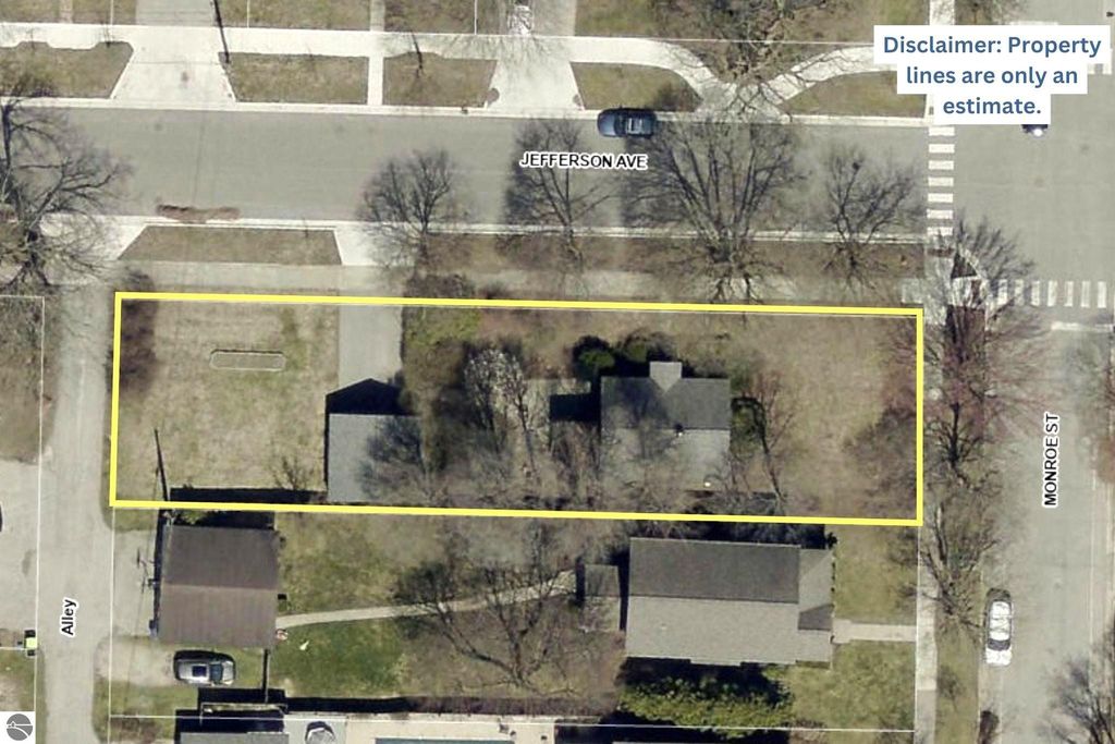 Aerial view of the property at 1101 Jefferson Avenue, Traverse City, MI, highlighting the oversized lot with outlined property lines, surrounding streets, and nearby homes, showcasing potential for renovation or new construction.