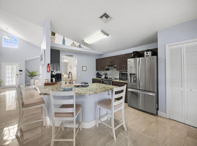 126 Hammocks Court, Greenacres, FL 33413