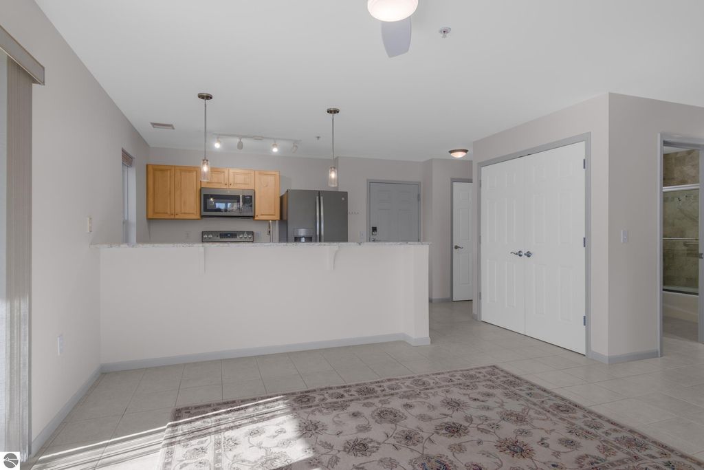 Modern kitchen and living area of a 2BR/2BA condo at 1122 Lake Ridge Drive, featuring updated cabinetry, stainless steel appliances, and a spacious layout with natural light.