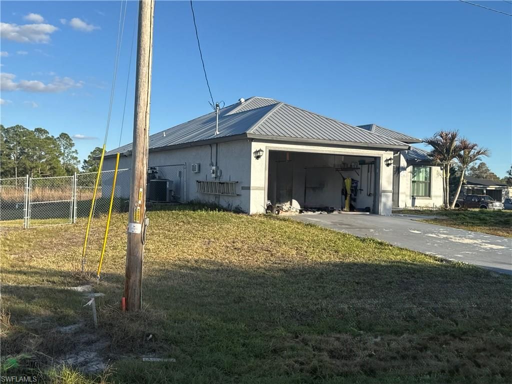 717 Fleming AVE S, LEHIGH ACRES, FL 33974 — exterior