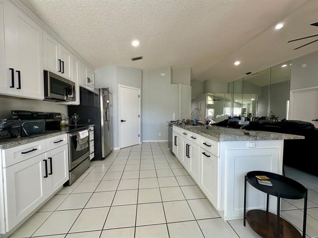 119 Hammocks Court, Greenacres, FL 33413