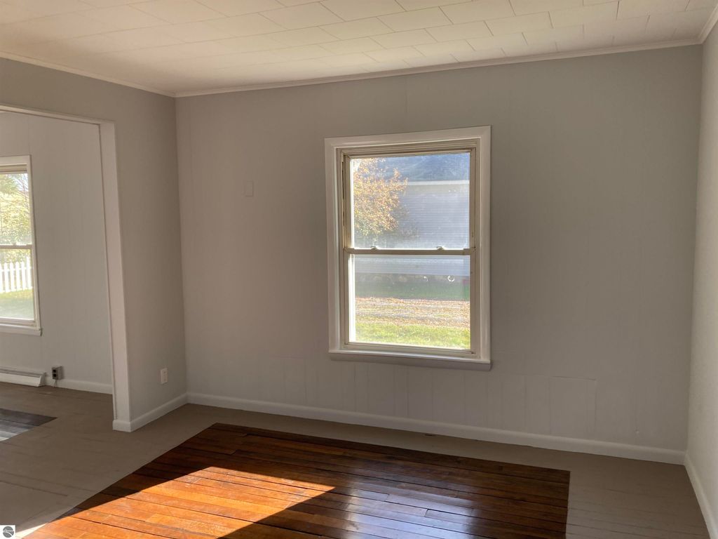 Bright interior of a cozy home in Rose City, featuring a large window with natural light, hardwood flooring, and neutral-colored walls, ideal for showcasing the living space of the property at 206 George Smith Jr. Street.