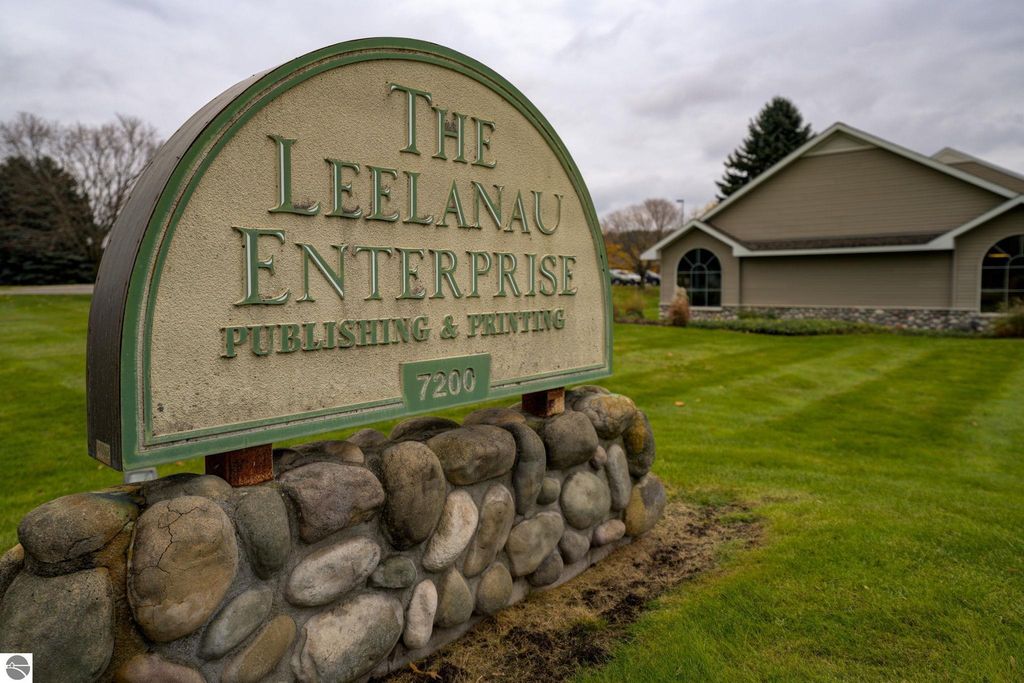 Sign for The Leelanau Enterprise Publishing & Printing at 7200 E Duck Lake Road, showcasing the commercial property in Lake Leelanau, MI.