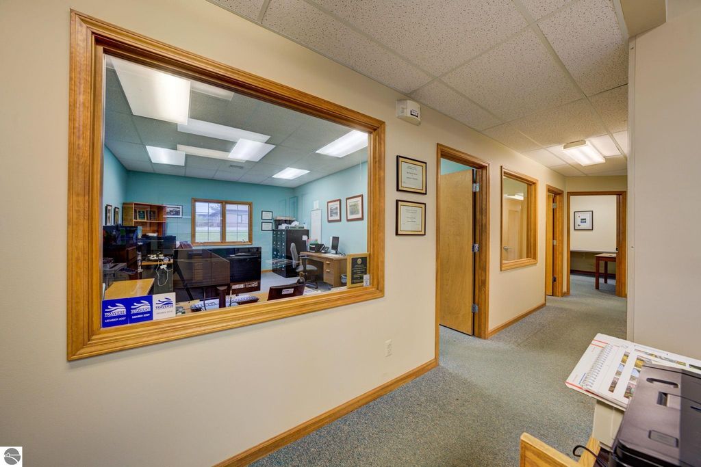 Office interior view showcasing reception area and workstations, highlighting professional workspace in commercial property at 7200 E Duck Lake Road, Lake Leelanau, MI.