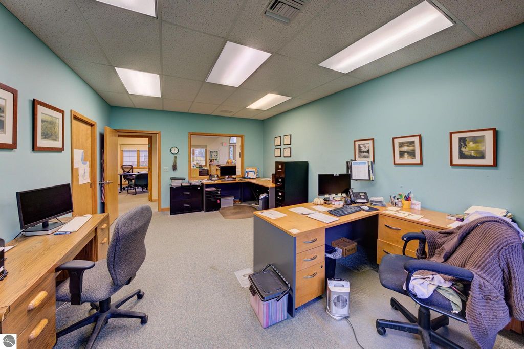 Office interior featuring desks, computers, and decor, showcasing a professional workspace environment suitable for commercial operations in Lake Leelanau.