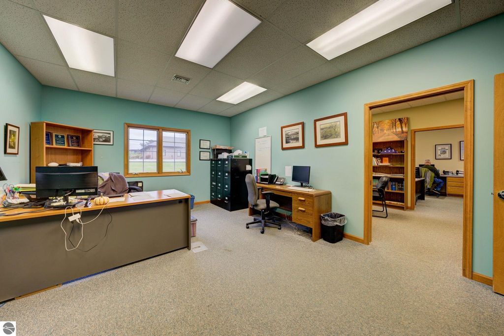 Office interior featuring desks, computers, and storage cabinets in a commercial building at 7200 E Duck Lake Road, Lake Leelanau, MI, suitable for business operations.