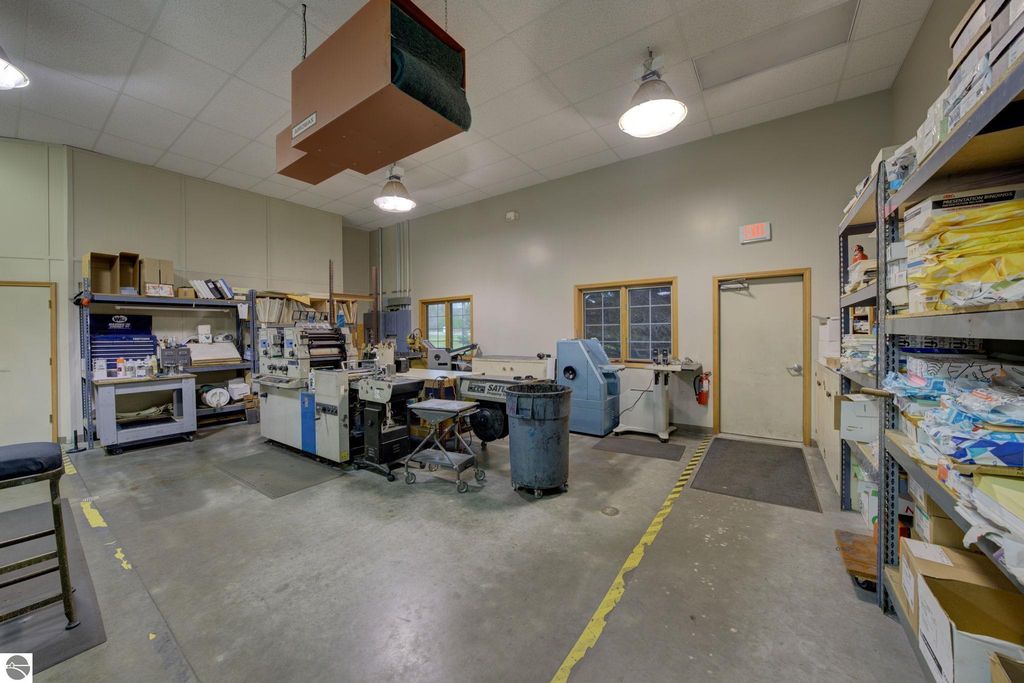 Interior view of a commercial production space featuring equipment, storage shelves, and workstations, relevant to the property listing at 7200 E Duck Lake Road, Lake Leelanau, MI.