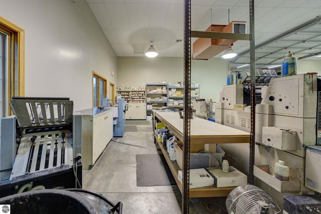 Interior view of a commercial workspace featuring production equipment, workstations, and storage areas, relevant to the leased business at 7200 E Duck Lake Road, Lake Leelanau, MI.