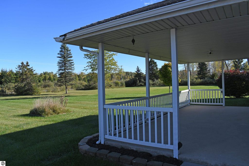 Porch view of ranch home at 2275 Noble Road, surrounded by 40 acres of lush greenery, showcasing a peaceful outdoor setting ideal for outdoor lifestyle enthusiasts.