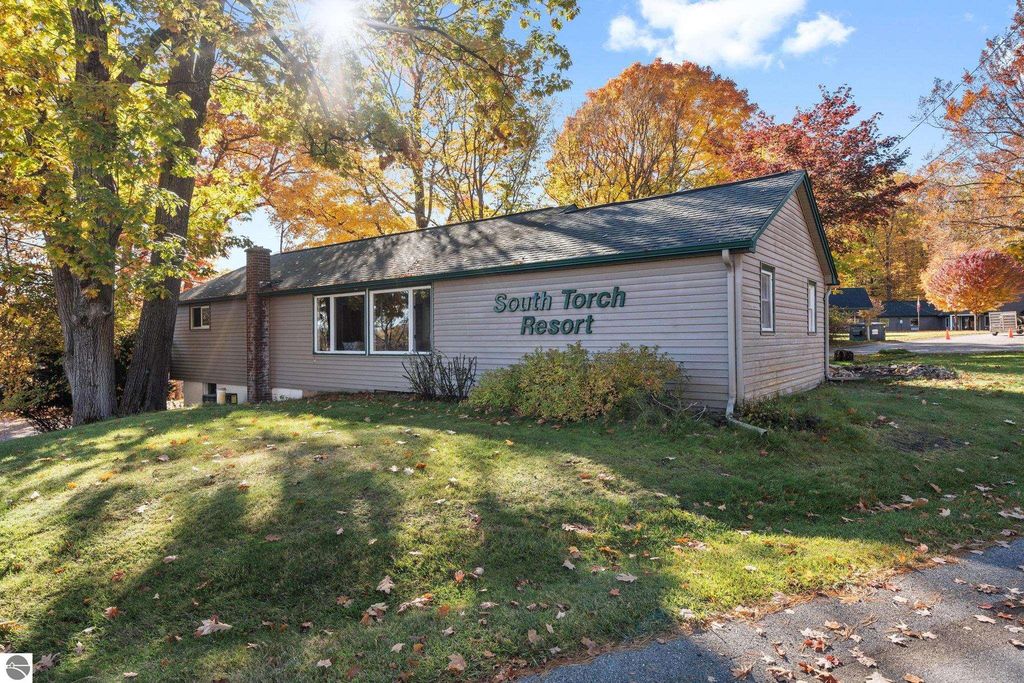 South Torch Resort building surrounded by colorful autumn foliage, highlighting the property’s appeal in Northern Michigan near Torch Lake.