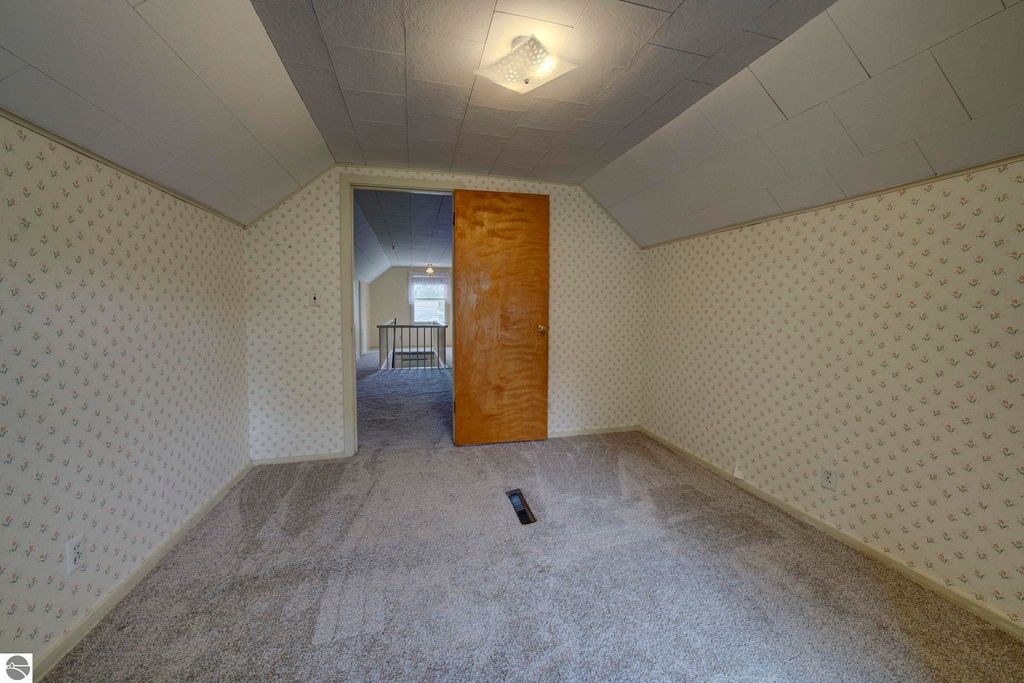 Upstairs den area in a well-maintained home at 624 Fenton Street, featuring plush carpet, floral wallpaper, and a doorway leading to additional rooms.