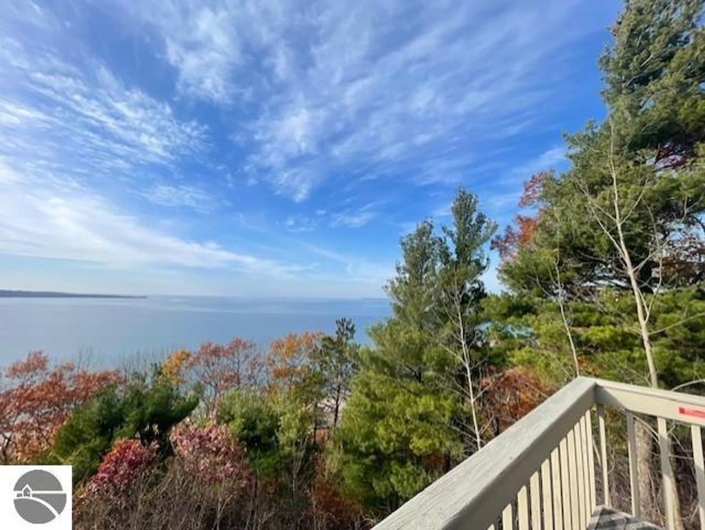 Panoramic view of Lake Michigan from 12C Pinnacle Place, showcasing autumn foliage and clear blue skies, highlighting the property's premium location in Glen Arbor, MI.